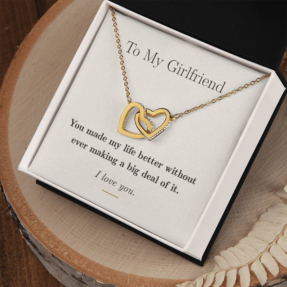 Close view of the two interlocking heart pendants set with cubic zirconia