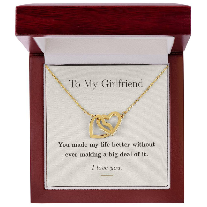 Interlocking hearts necklace shown in the 18K yellow gold finish